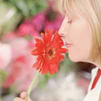 Lady smelling a flower